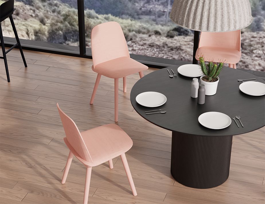 A modern dining room featuring pink chairs, a black table, and a cactus centrepiece, with a scenic outdoor view through a glass window.

