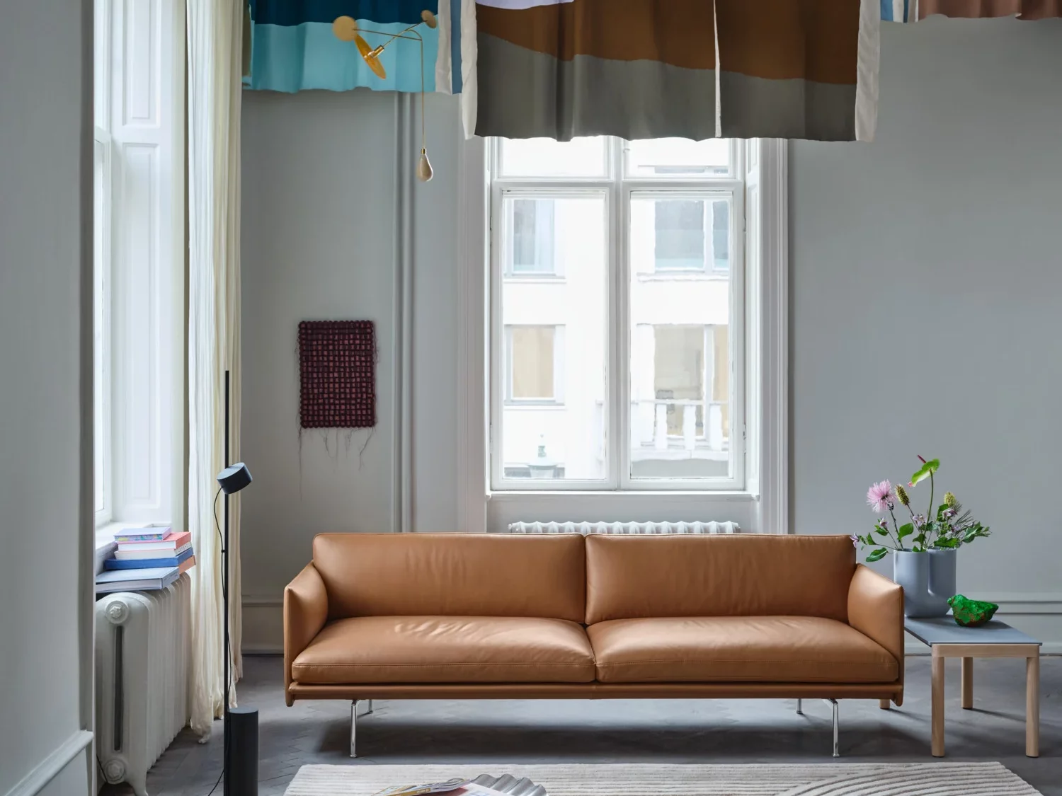 A serene living room space with a tan leather sofa.