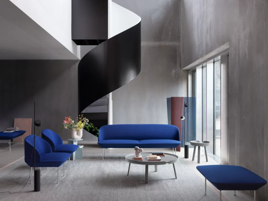 A contemporary living space with blue lounge chairs and sofa.




