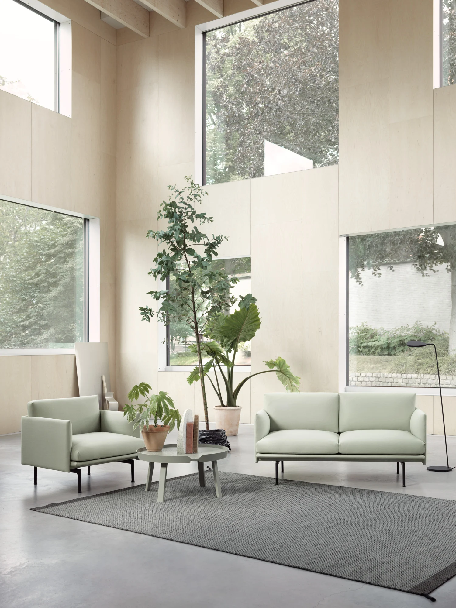 Light green 2-seater sofa and armchair in a modern living room.