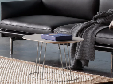 A minimalist coffee table with a light wood surface.