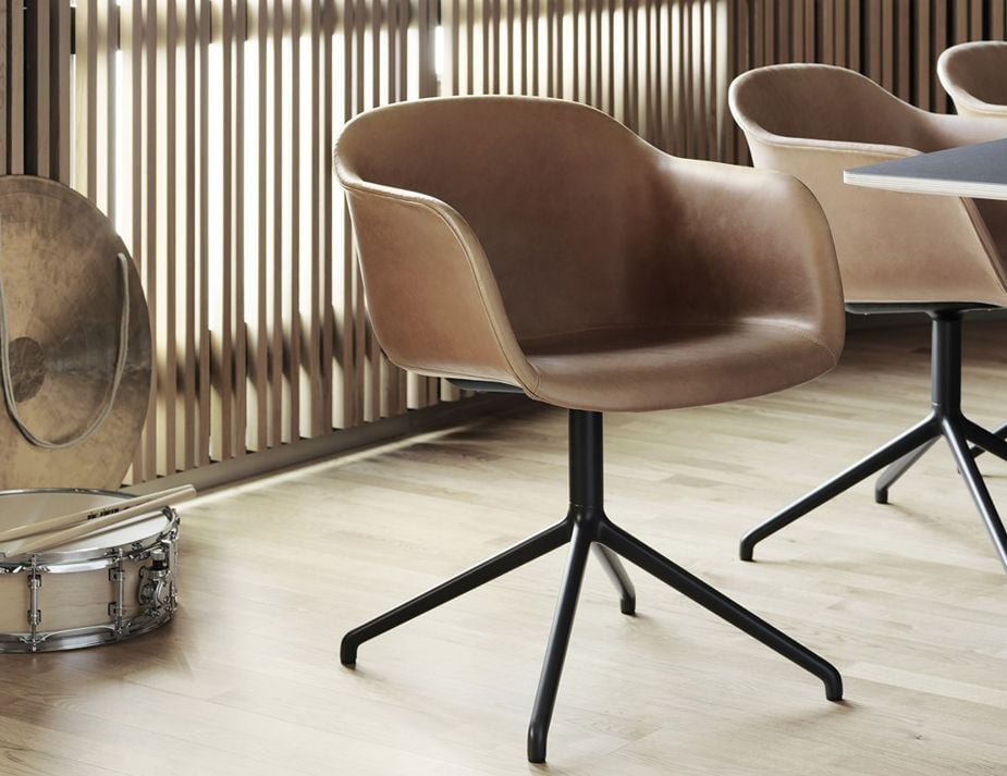 A contemporary room with brown leather chairs.