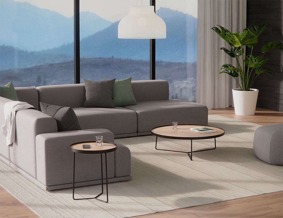 A serene living room with a round wooden coffee table.