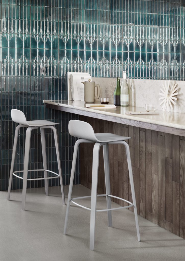 Grey wooden bar stool at bar height. 
