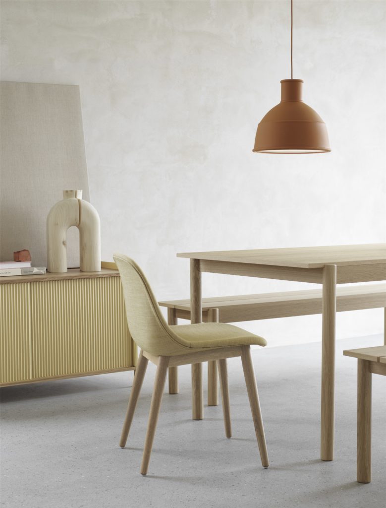 designer muuto terracotta coloured pendant hanging over a dining table
