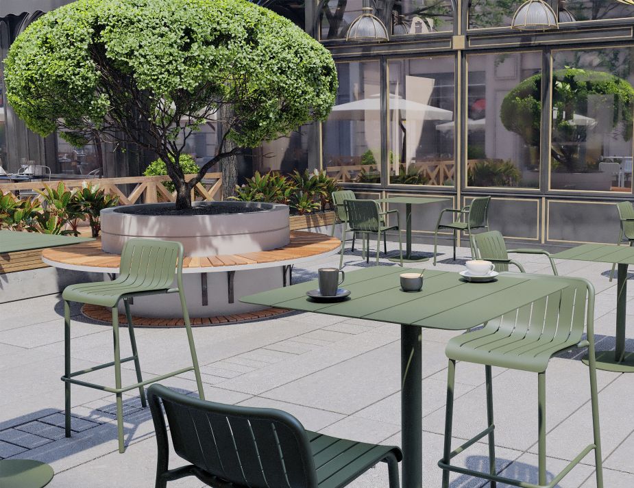 A serene outdoor cafe setting featuring well-maintained green metal tables and chairs, emphasizing the importance of outdoor furniture care. In the centre, a robust tree with a lush canopy is planted in a raised circular bed, surrounded by wooden seating. 