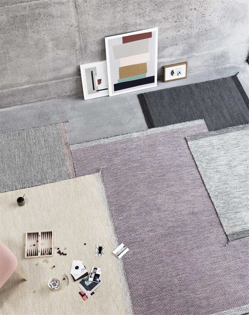 coloured rugs on floor of concreate home