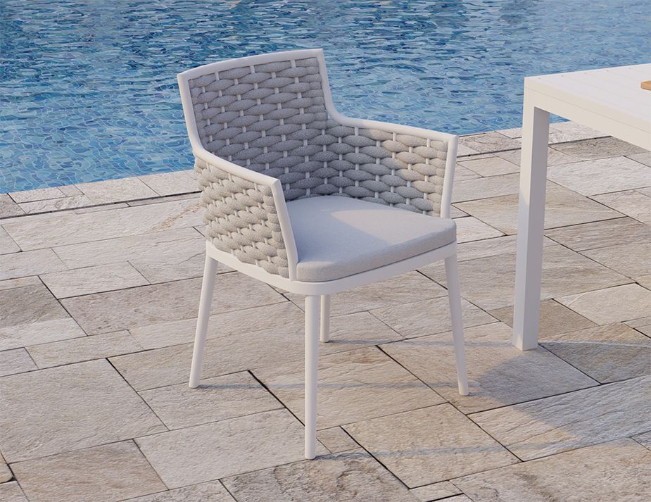 A stylish chair next to a pool, which appears to have a woven back and a cushioned seat. The design seems modern, with a combination of textures that contrast nicely with the smoothness of the surrounding tiles and the water in the pool.