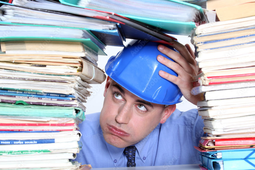 An overwhelmed man with a blue hard hat.