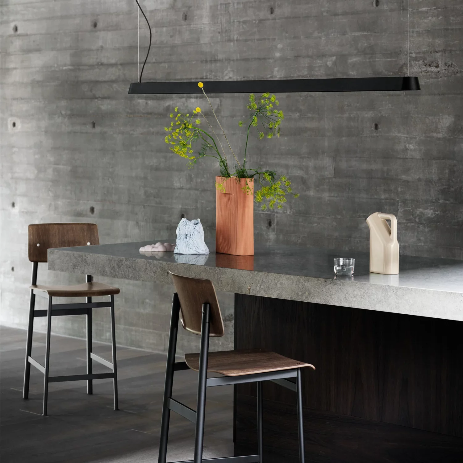 Dining space featuring a stone countertop and wooden kitchen stool.