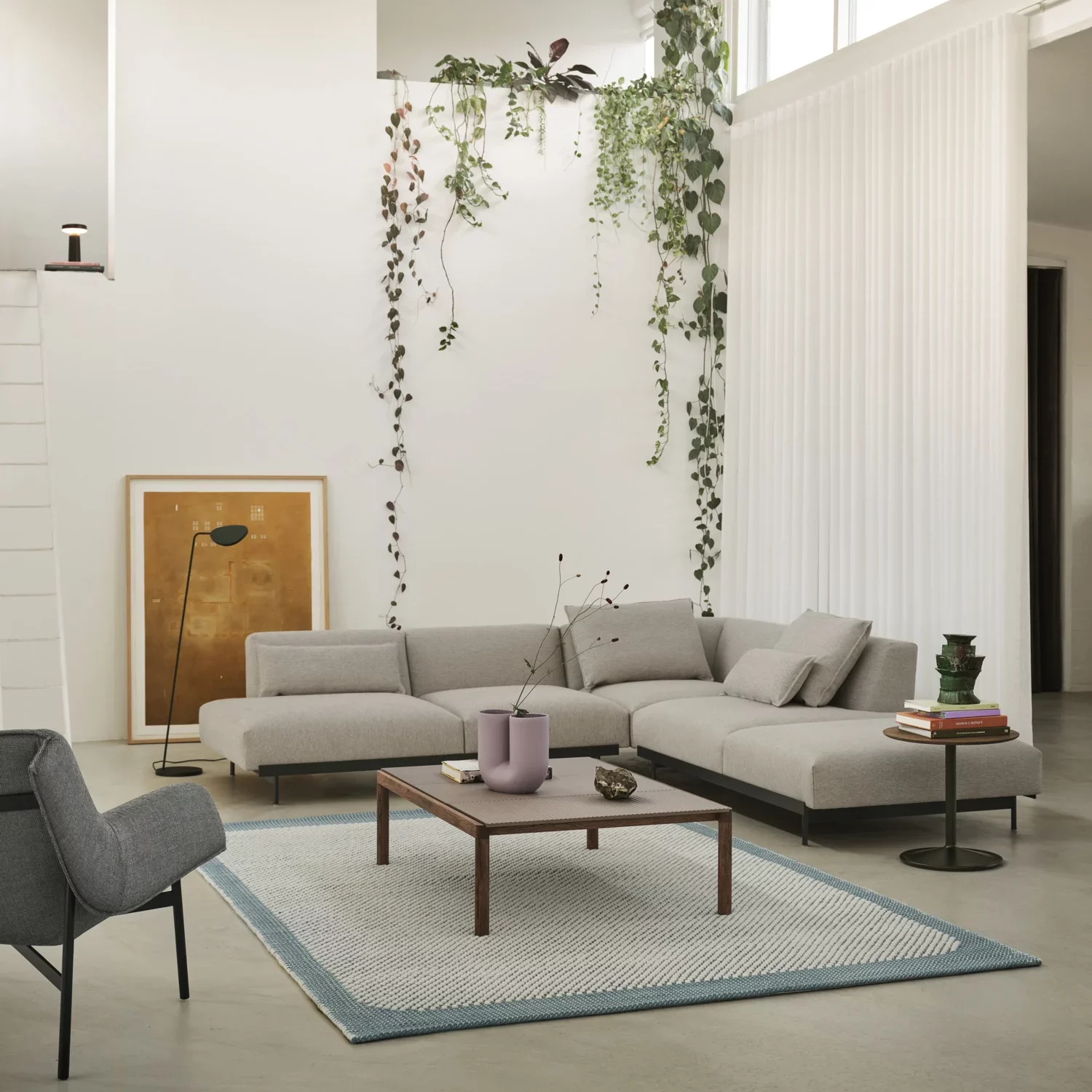 Spacious living room with a light grey couch and wooden coffee table.