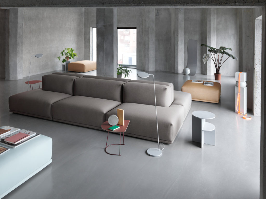 Minimalist living room with concrete finish and modular sofa.