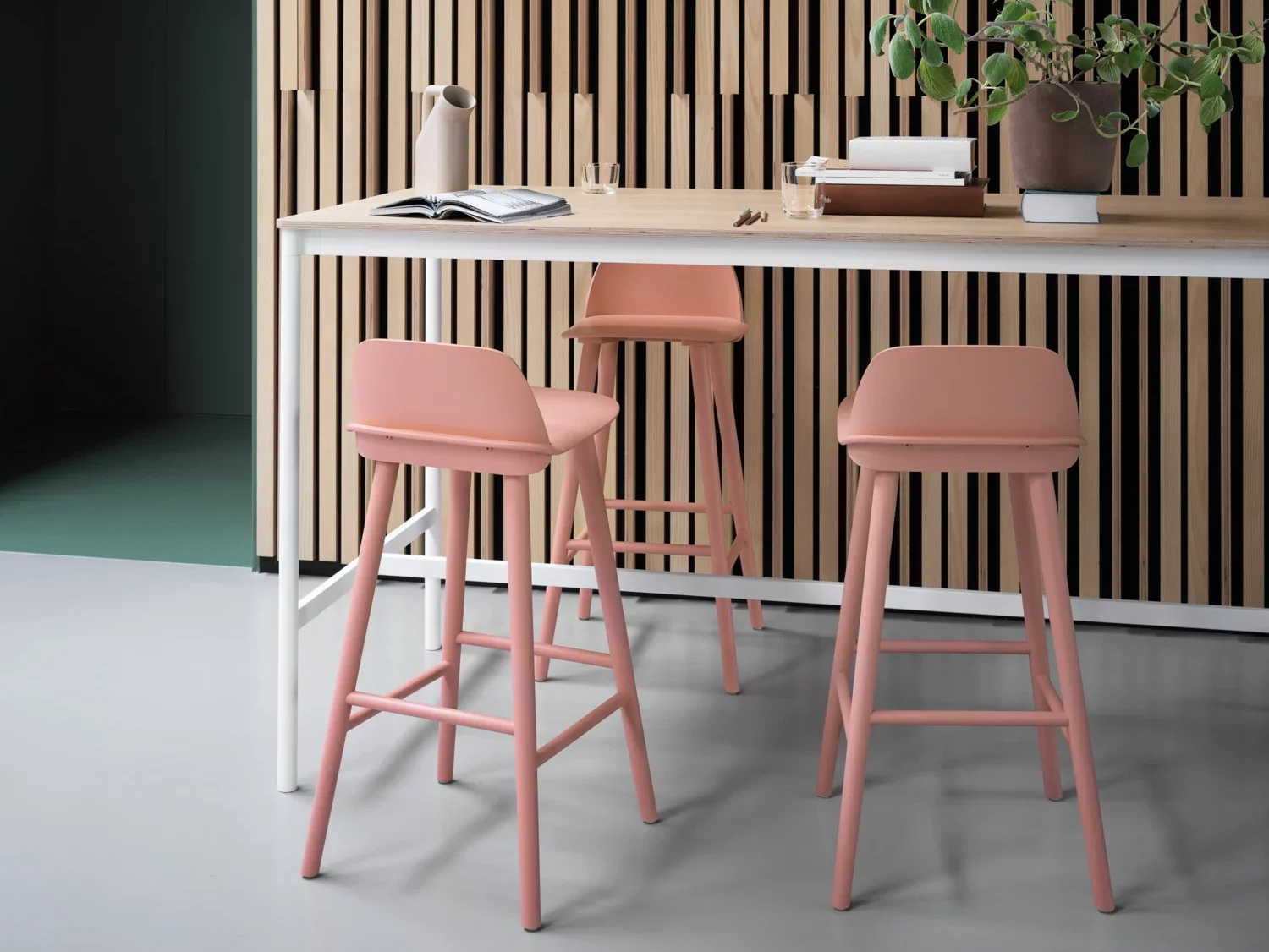 Elegant kitchen interior with pink bar stools.