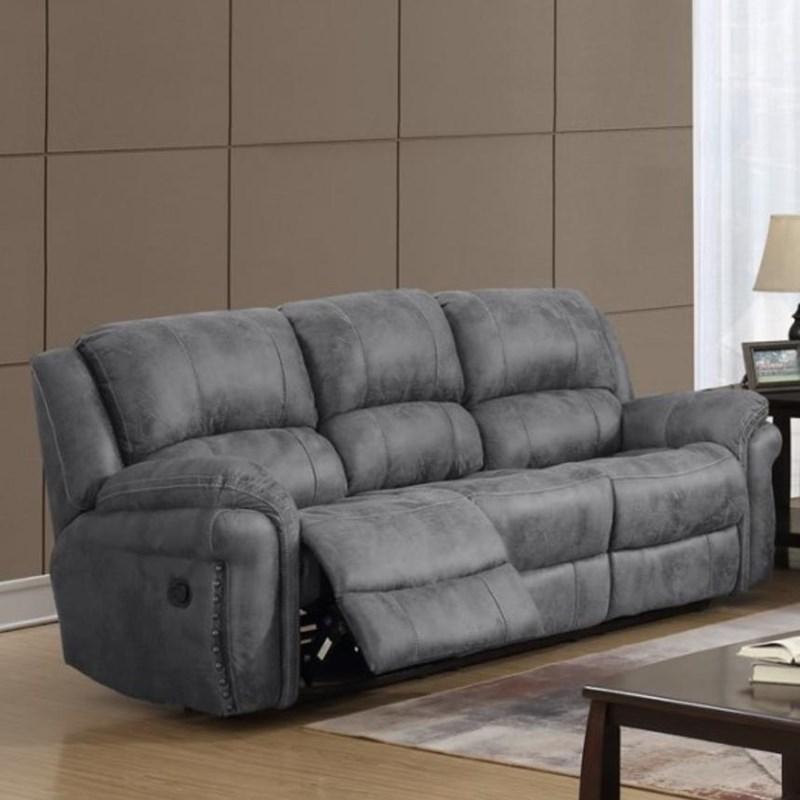 A plush, gray, tufted reclining sofa set against a neutral backdrop.
