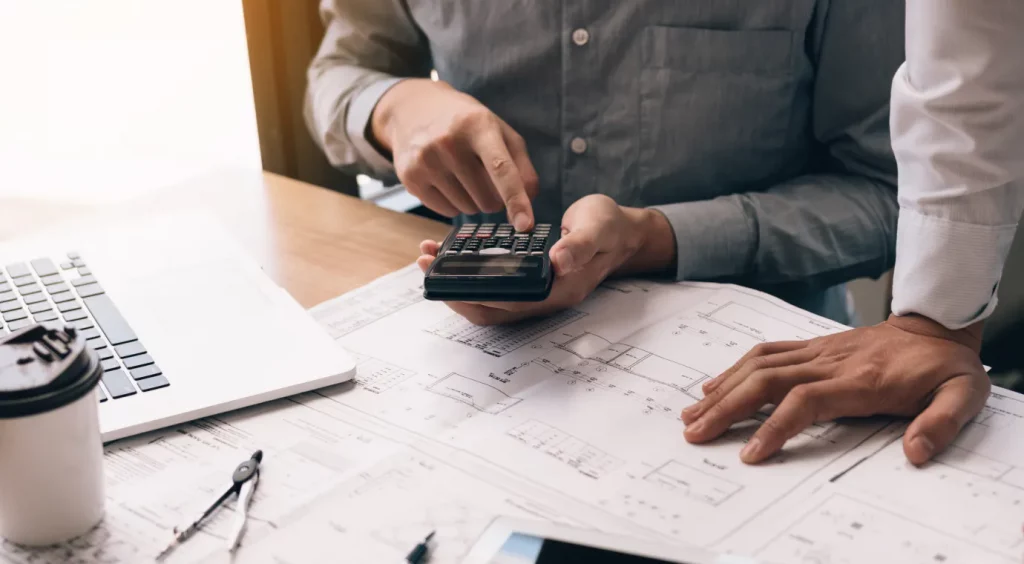 Close-up of a man's hands using a calculator.