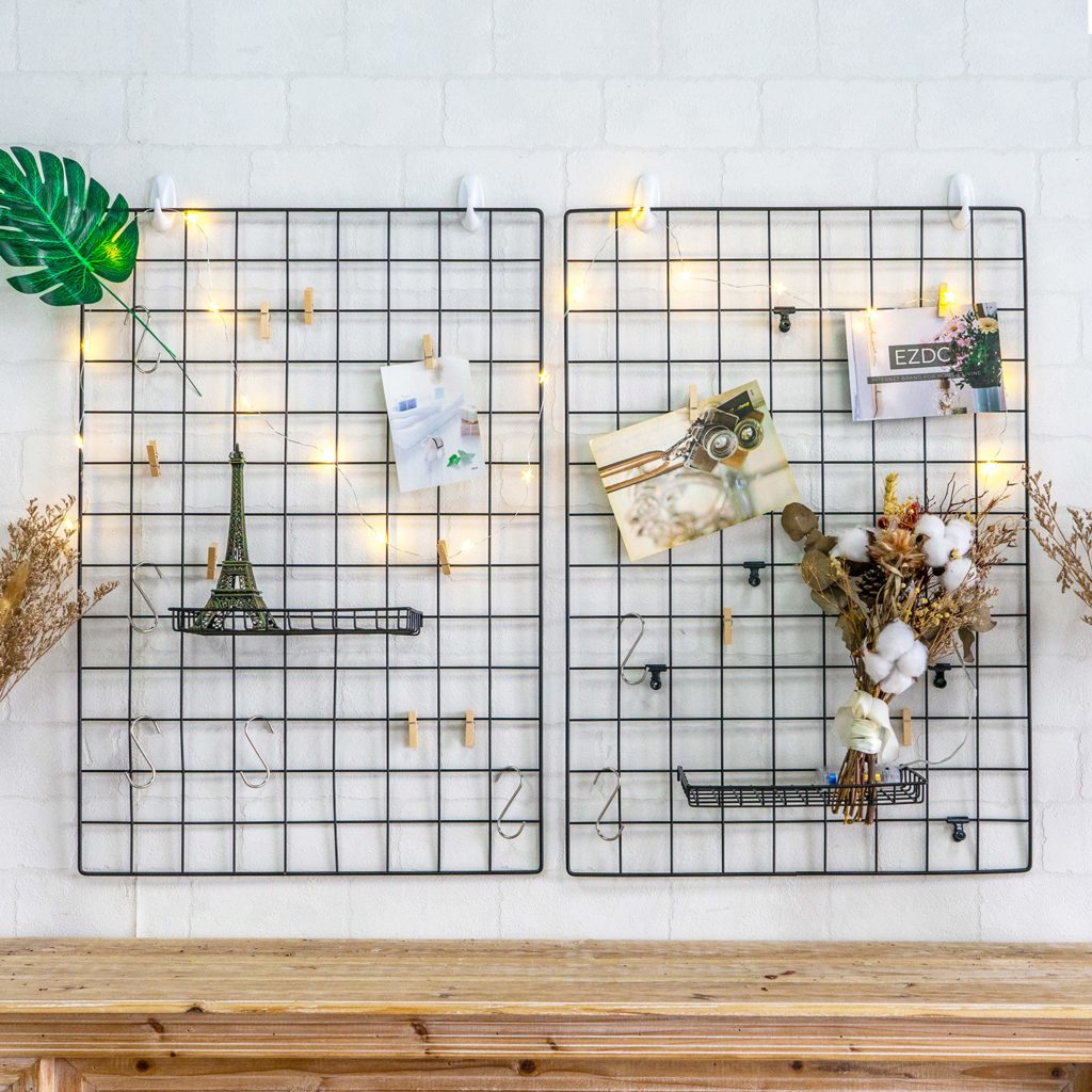Wall-mounted wire grids adorned with fairy lights.
