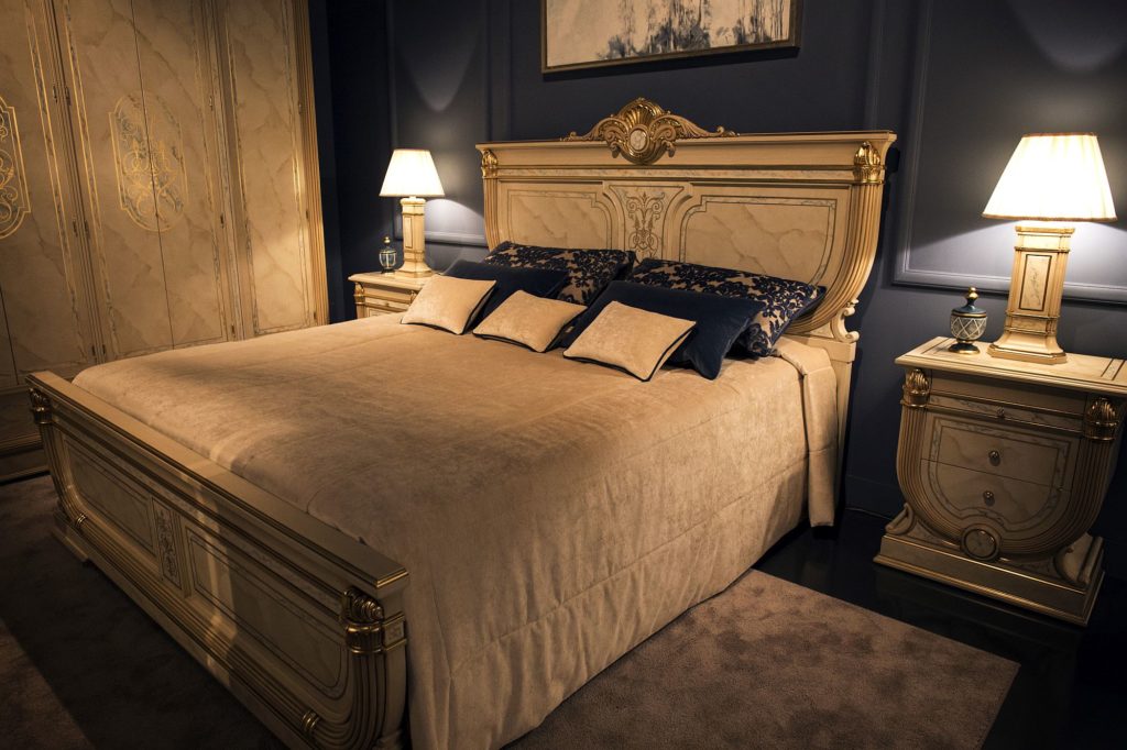 A luxurious bedroom with a regal gold and blue theme.