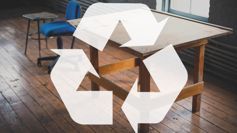 Wooden table with a recycle symbol over it.