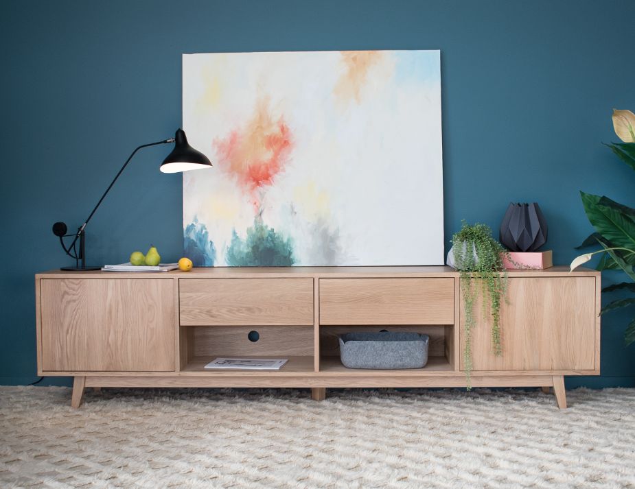 A contemporary living room with wooden console table.