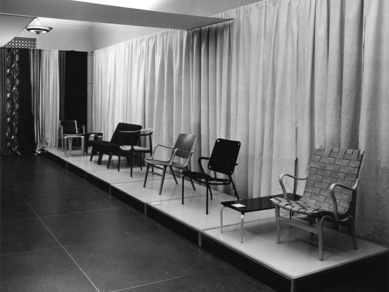 A vintage photograph of a row of Danish design chairs.
