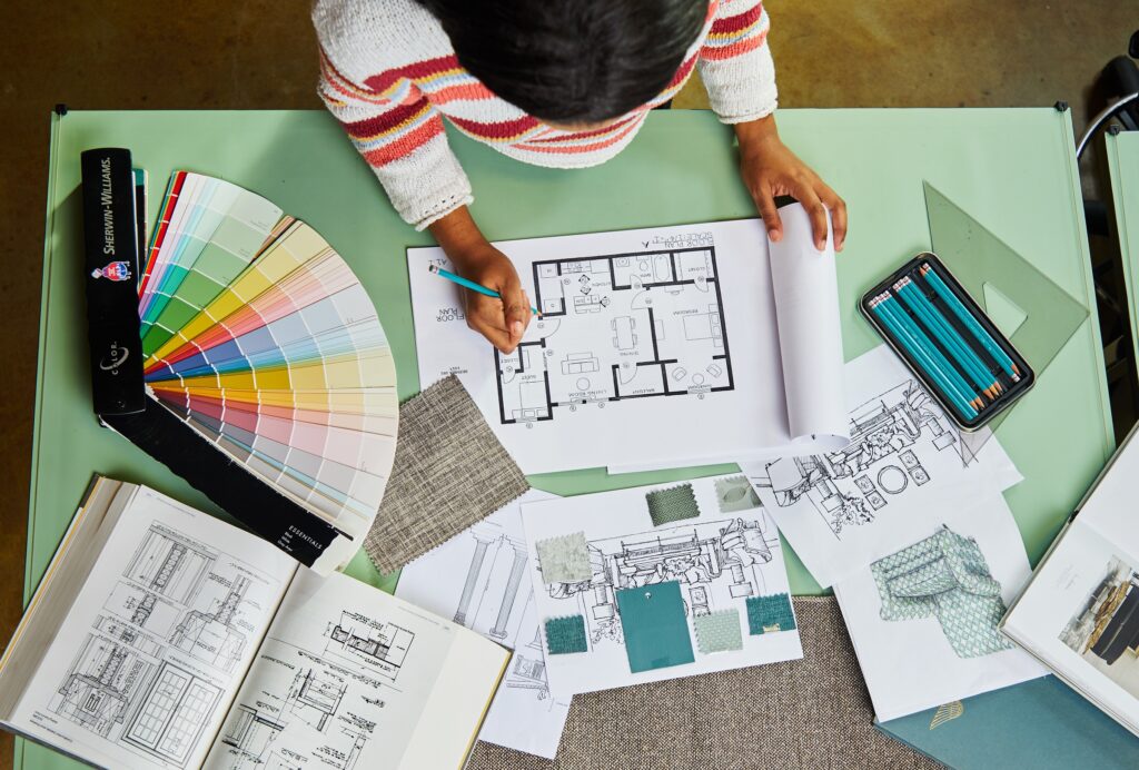 A designer working on architectural drawings and design.