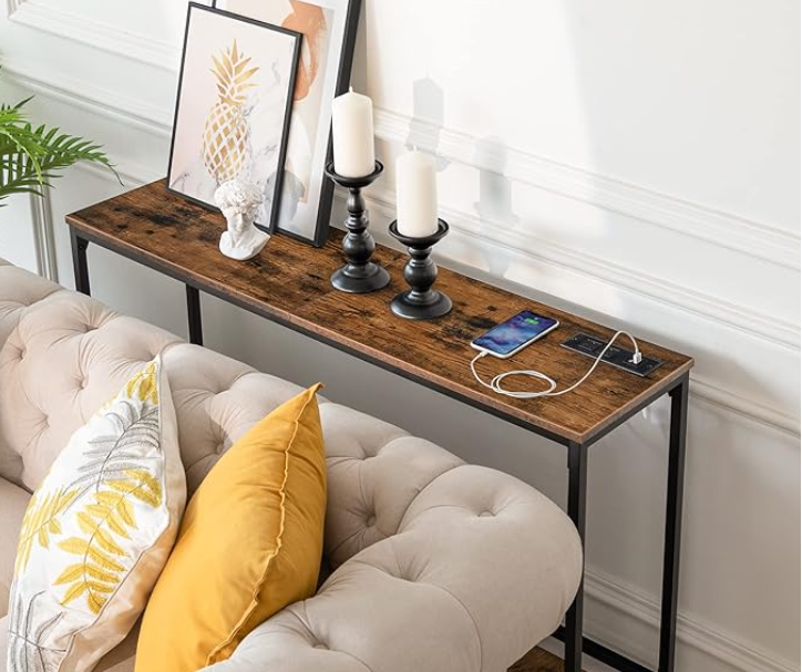 Rustic wooden console table against a blue wall. 