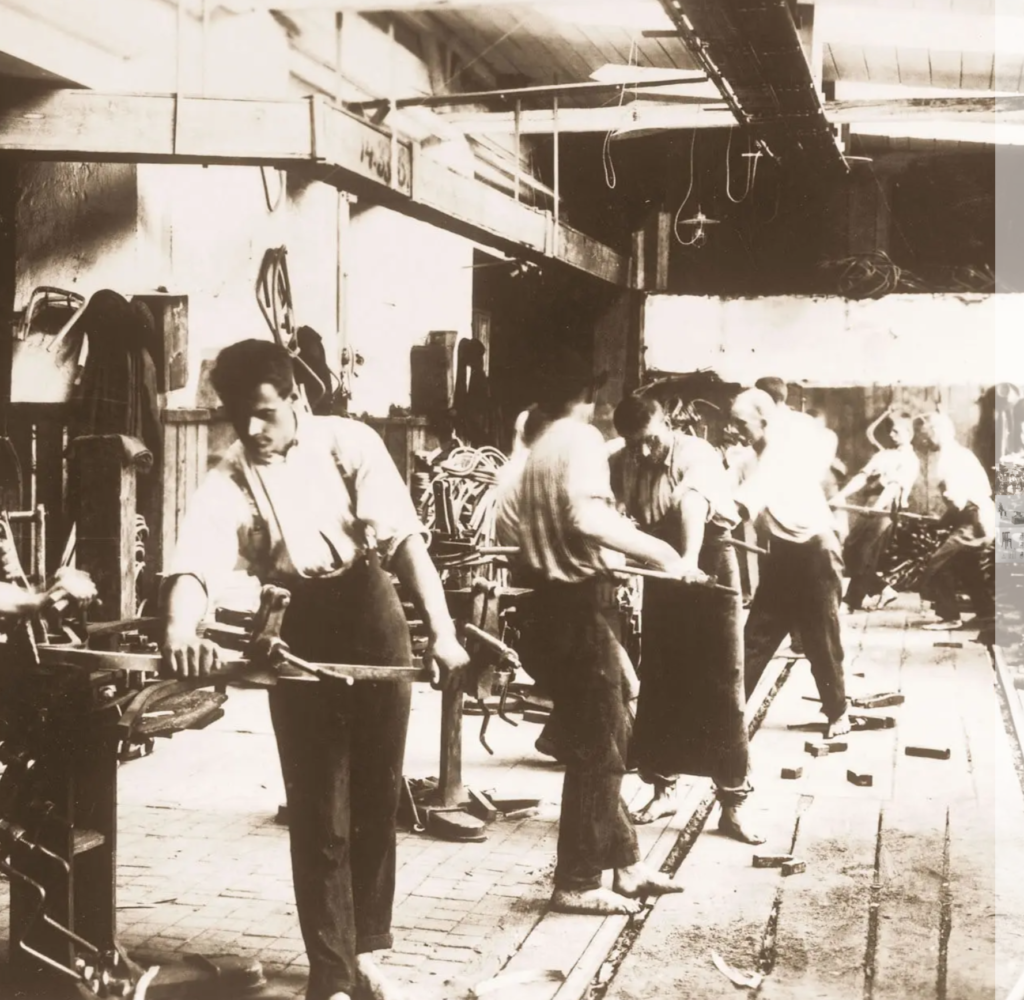 Black and white photograph of workers in a workshop.