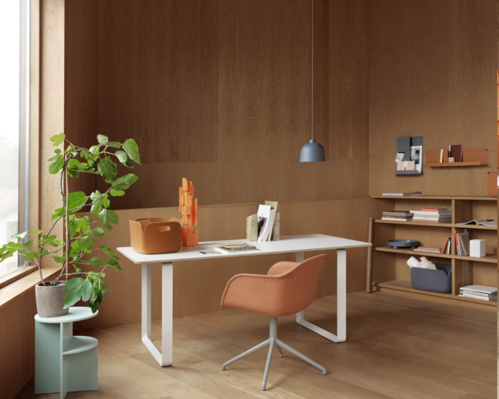 Sleek home office with wood panelling and white desk.