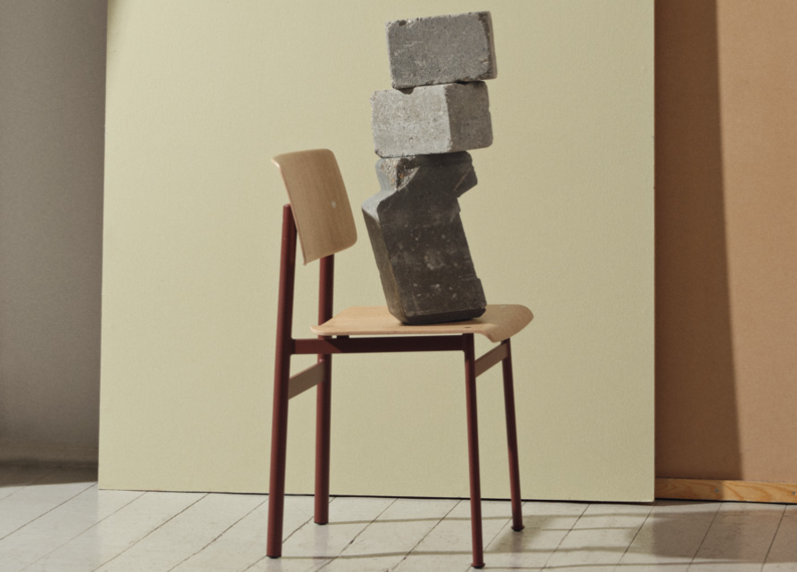 Stone stacked on a wooden chair.