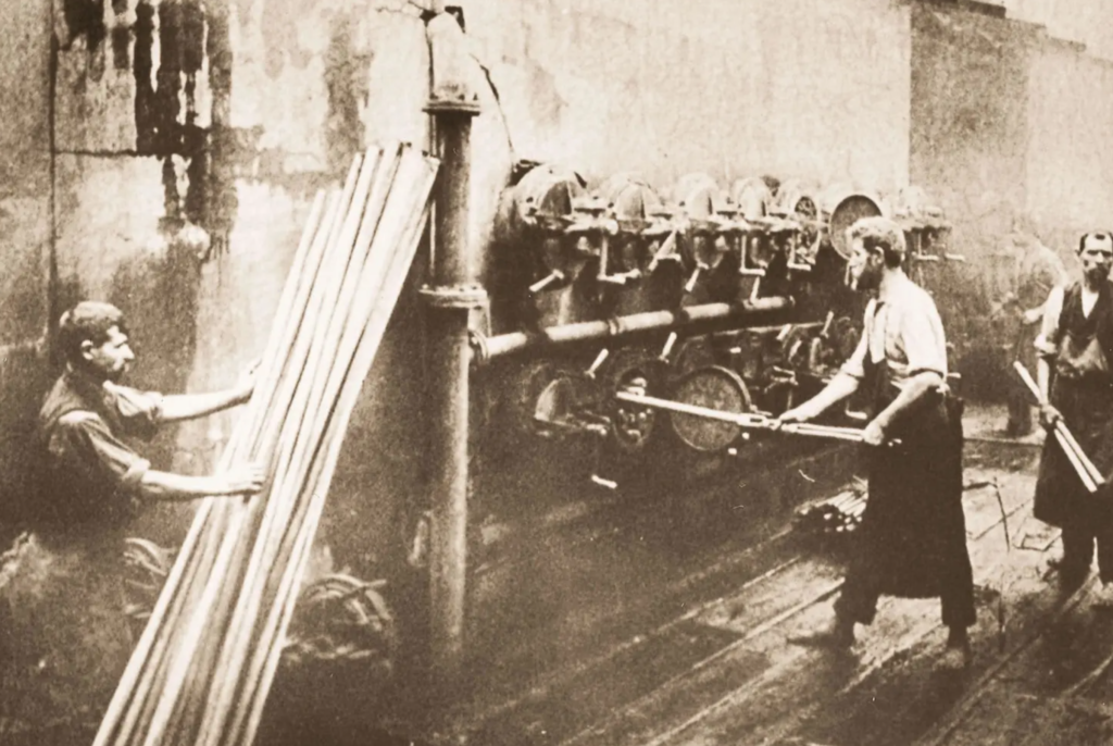 Photograph capturing workers in an industrial setting. 