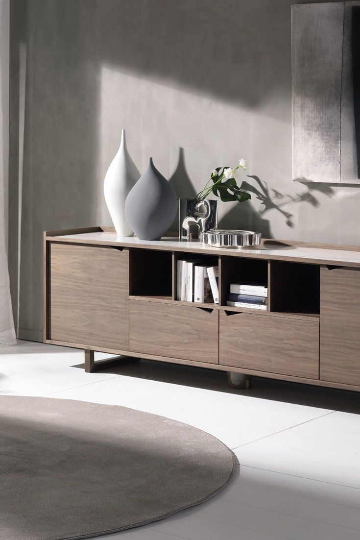 A living room corner featuring a sleek wooden console table.