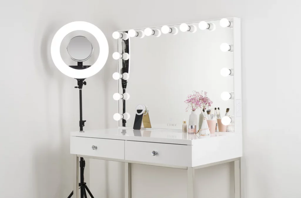 A modern vanity setup with a white table & mirror.