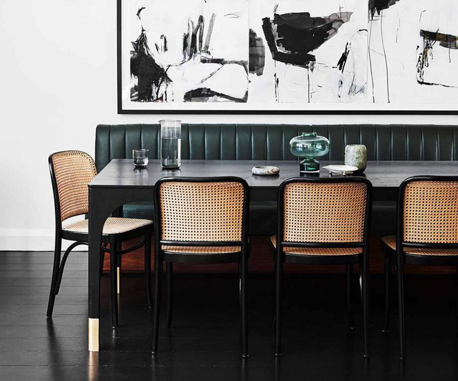 Dining space with a black table & chairs.