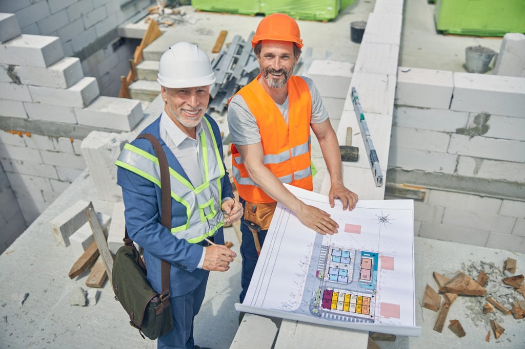 Two smiling construction professionals