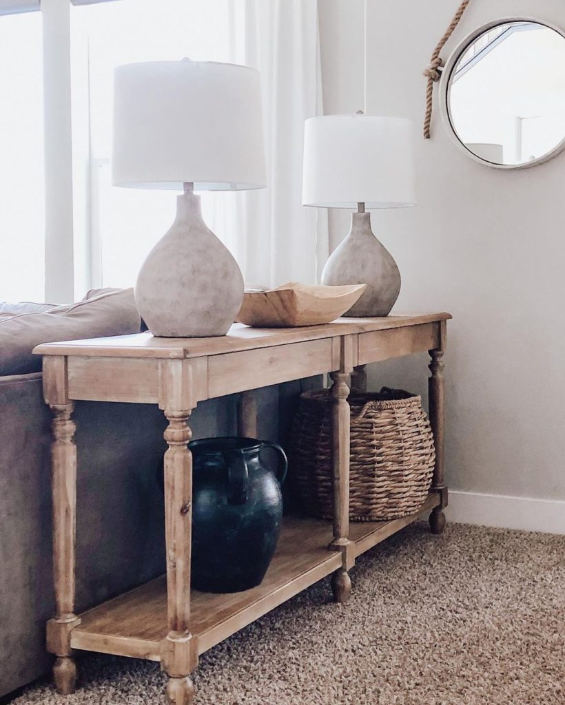 Two grey table lamps on a rustic wooden hallway table. 