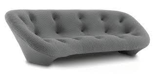 A grey tufted modern sofa.
