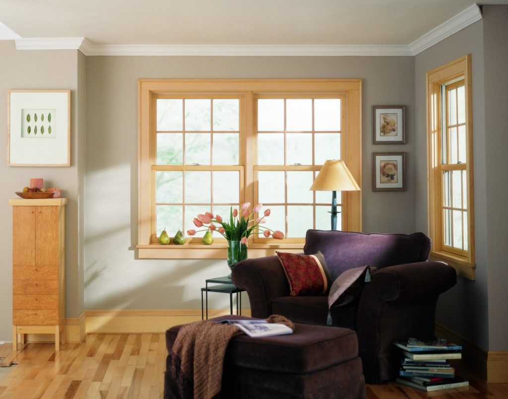 Cozy corner with armchair and floor lamp by window.