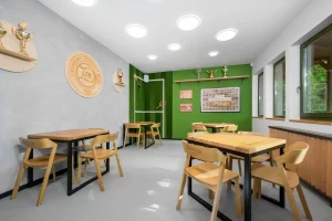 A sports-themed cafe displaying wooden tables and chairs.