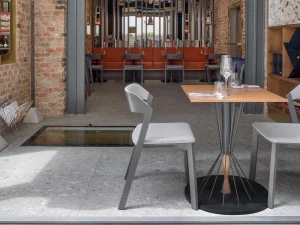 An outdoor dining area with TON grey chair.