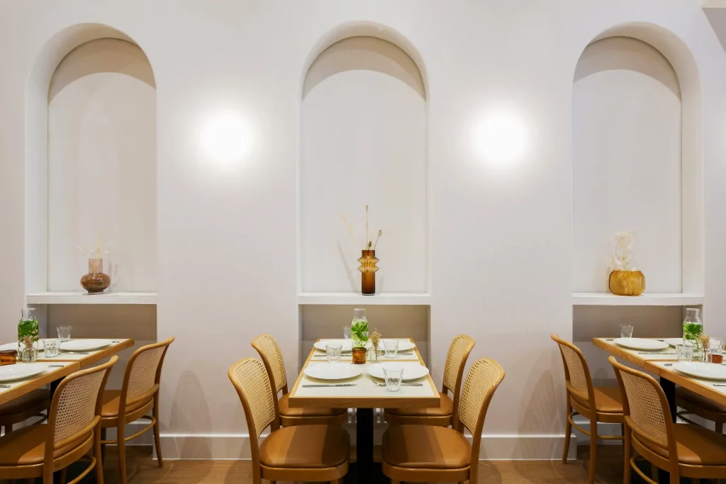 A dining area featuring rattan chairs with leather cushions.