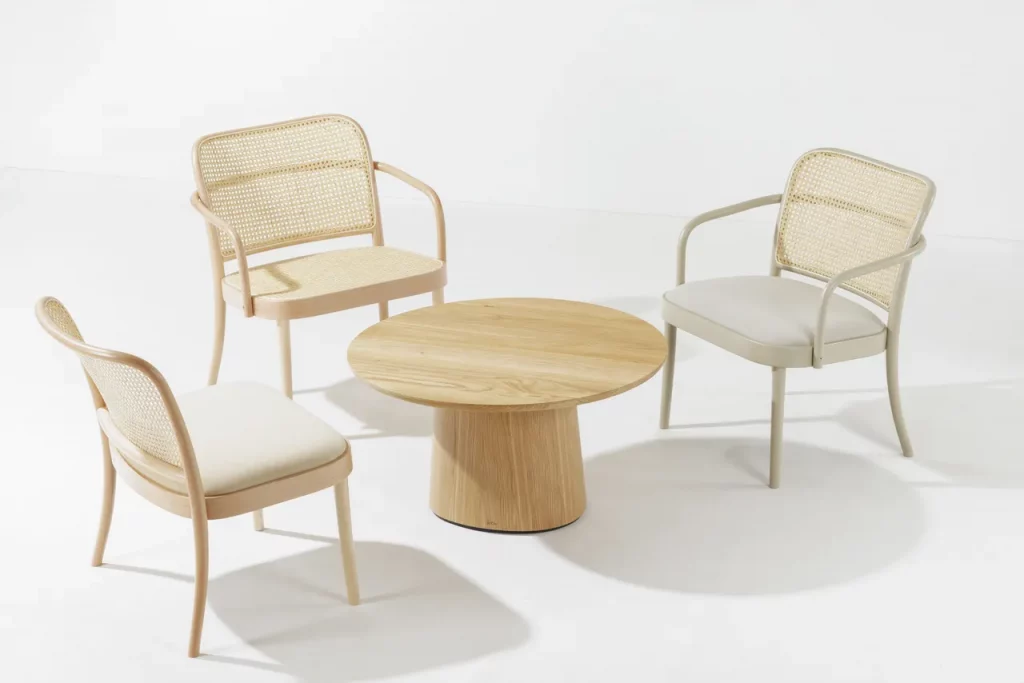 Light beige woven chairs around a wooden table.