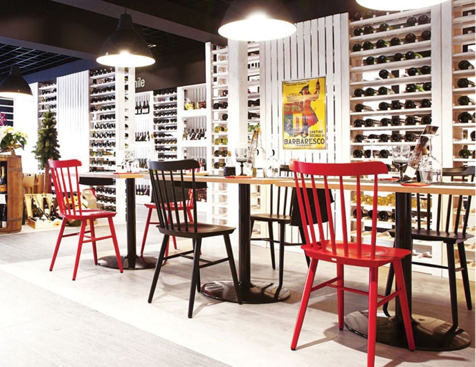 Contemporary wine store interior with a dining setup.