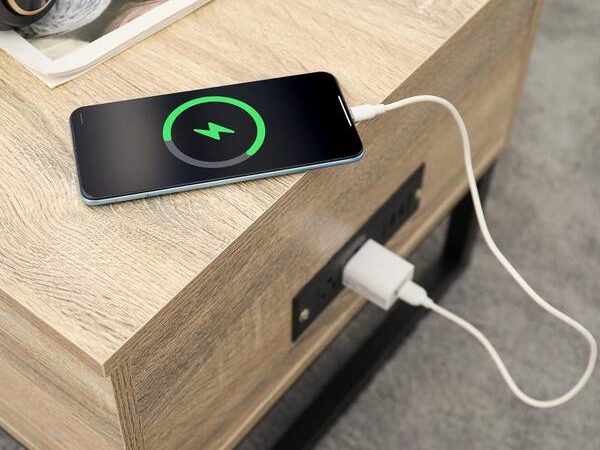 Wooden coffee table with integrated power outlets.