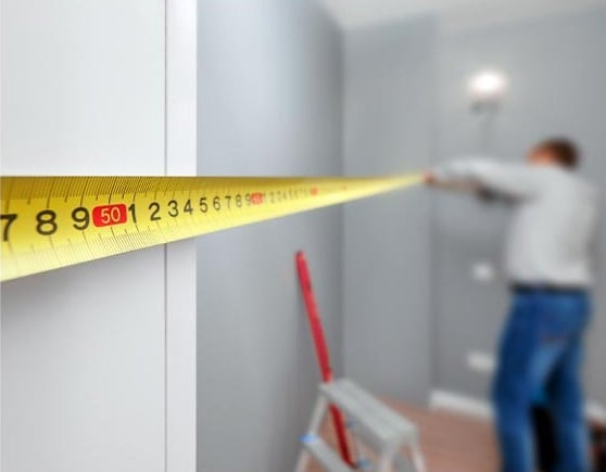 measuring your space interior design remodeling rochester hills A close-up of a yellow measuring tape.