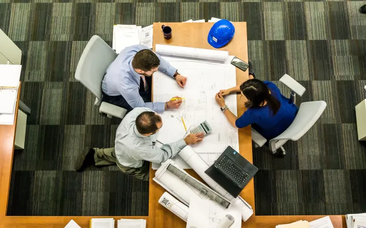 Group of professionals discussing a building layout.