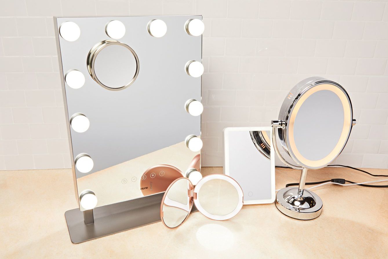 A makeup station displaying a rectangular and round mirror.