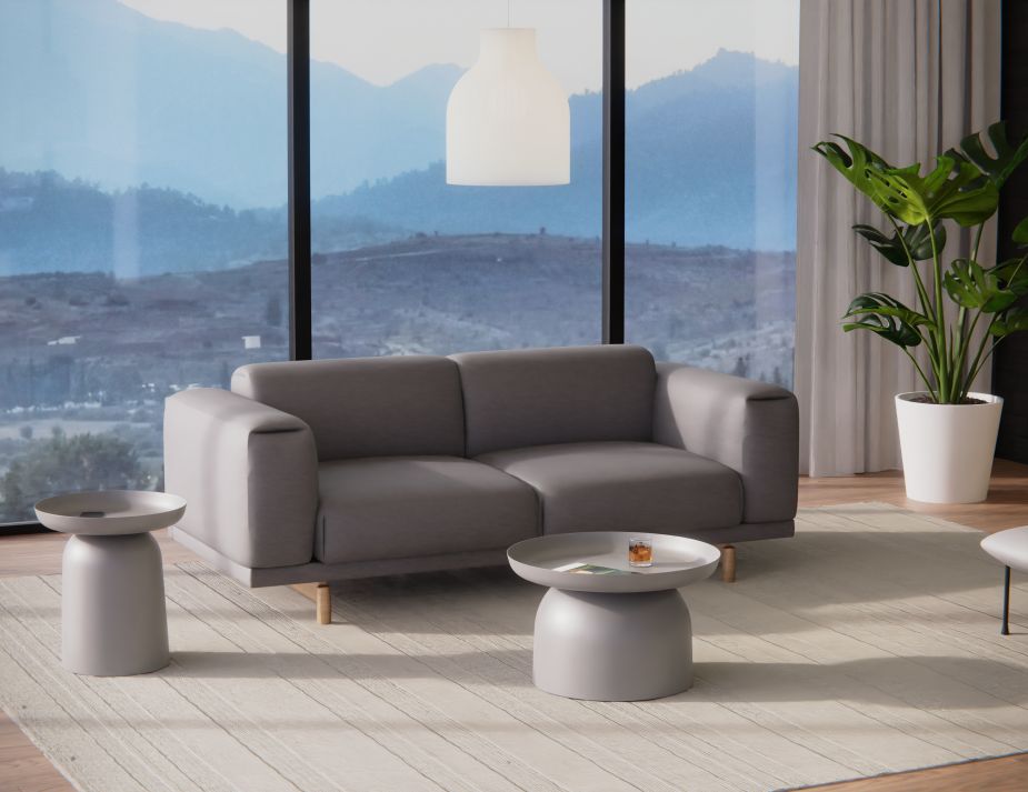 A contemporary living space with round modern grey coffee tables.
