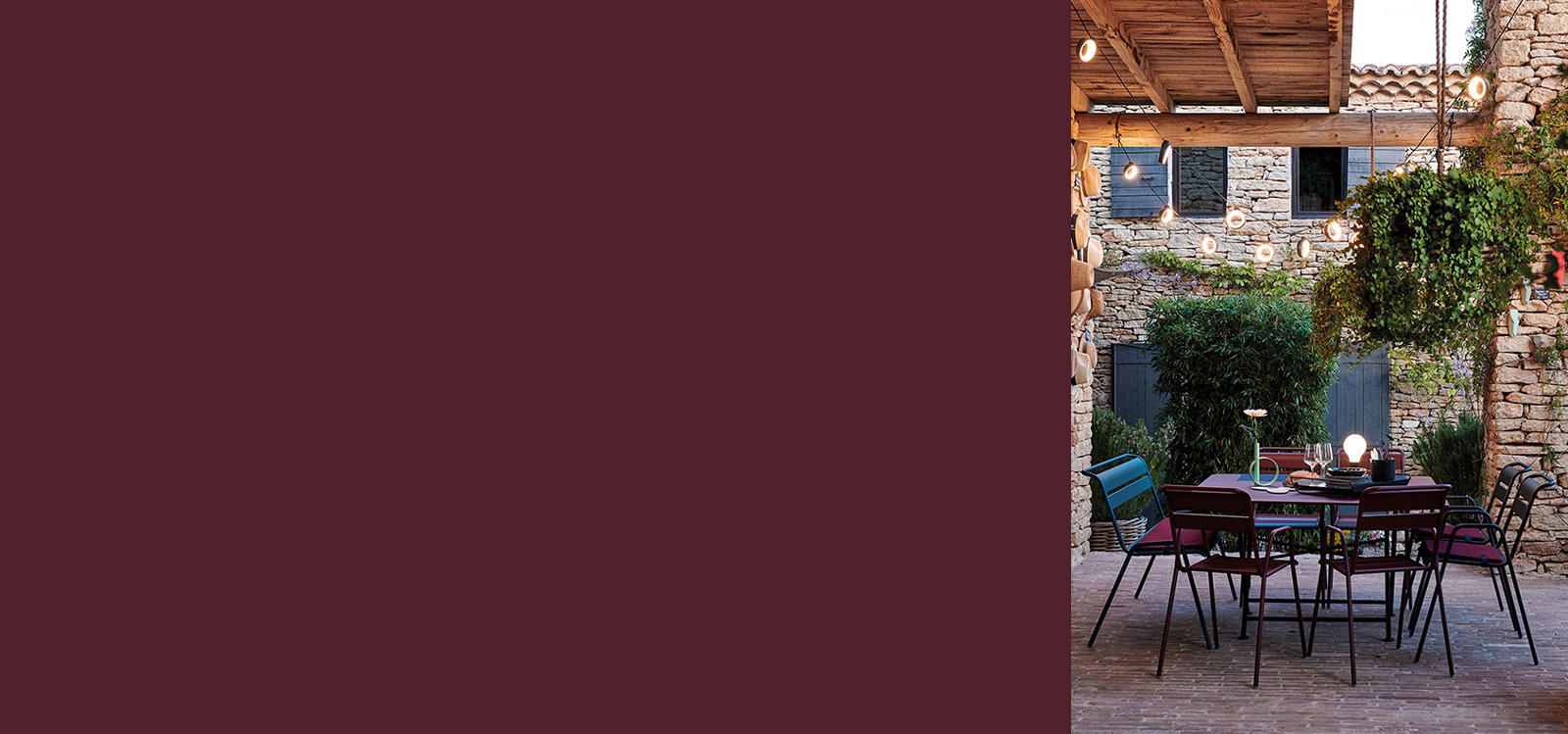Fermob Black Cherry Furniture in an outdoor setting at dusk
