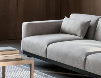 grey 3 seat sofa in wood panelled room
